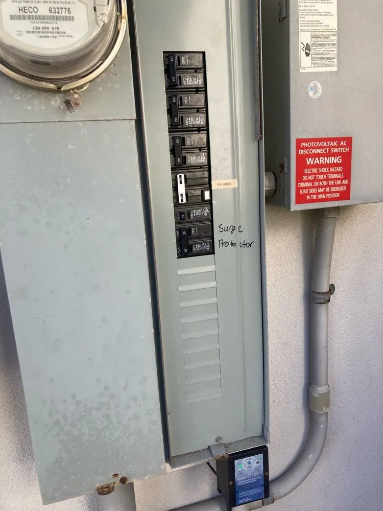 HECO meter, electrical panel, and surge protector serviced at a Kaneohe, Hawaii home by Sparky and Sons